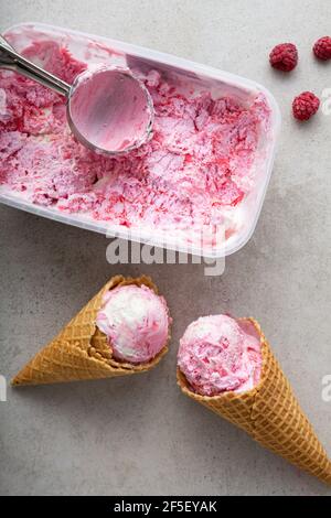 Two waffles cones with pink ice cream and box top view Stock Photo