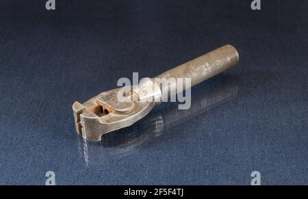 An old tool for a locksmith lies on a glass table. Details on a black background Stock Photo