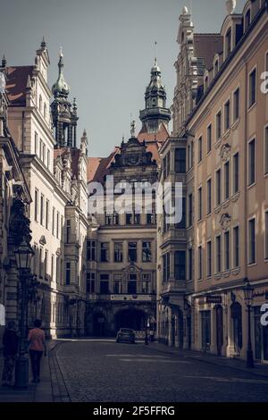 17 May 2019 Dresden, Germany - Ancient narrow streets of Dresden. Castle tower on background. Stock Photo