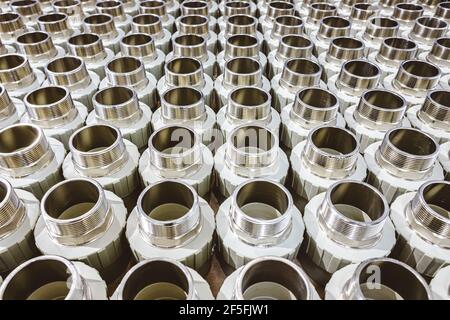 many metal pipe couplings in a pipe factory Stock Photo