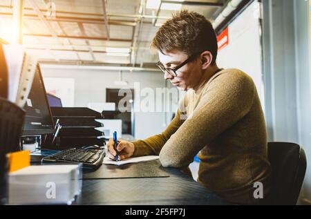 Engineer designer working on desktop computer in factory Stock Photo