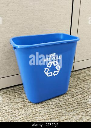A small blue recycling office trash bin recycling logo Stock Photo