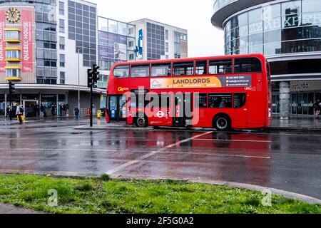 London UK, March 26 2021, Red Double Decker Public Transport Bus At Traffic Lights On A Empty Street. Stock Photo
