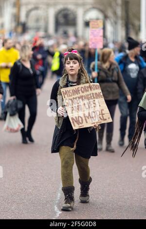 Anti-lockdown and anti Covid-19 vaccination protest, London, 20 March 2021. Portrait of a girl with placard. Stock Photo