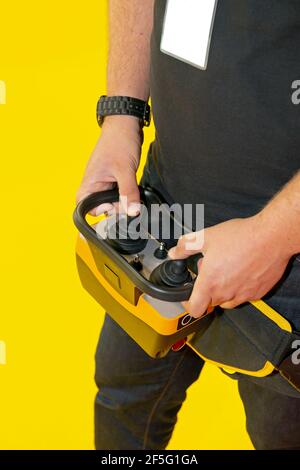 Worker Holding Remote Control With Joysticks for Construction Machinery Stock Photo