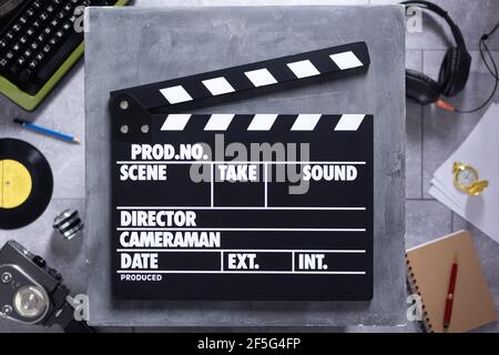 Movie clapboard or  clapper at old table. Clapperboard and screenwriter or movie writer concept design Stock Photo