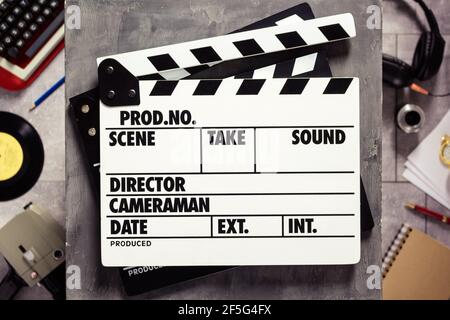 Movie clapboard or  clapper at old table. Clapperboard and screenwriter or composer  concept Stock Photo