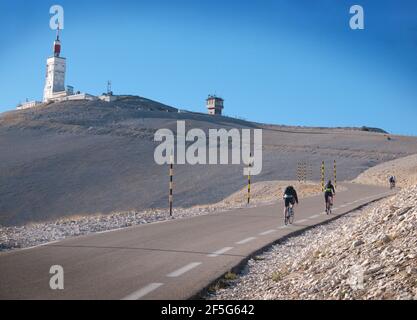 Cyclists ride towards the summit of Mont Ventoux on the southern Bédoin side. Vaucluse, Provence, France Stock Photo