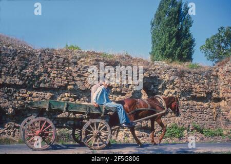 Two men riding on horse drawn cart Iznik Turkey. Stock Photo