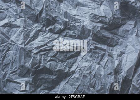 background from crumpled texture paper of dark gray color, a template for the text Stock Photo