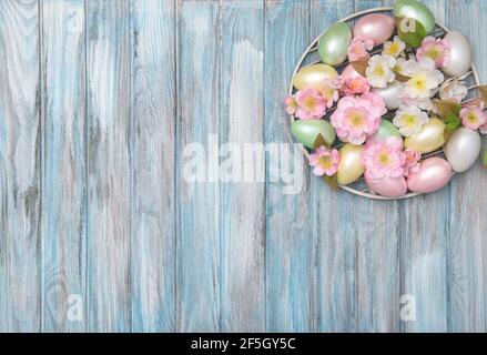 Easter eggs with floral decoration on blue wooden background Stock Photo