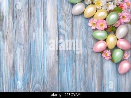 Easter background. Colorful eggs with pink spring blossoms Stock Photo