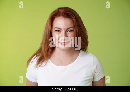 Enthusiastic smiling redhead middle-aged woman grinning joyfully alluring motivated gaze camera determined reach goal happy watching grandson playing Stock Photo