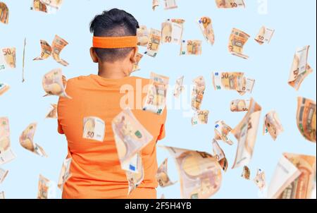 Little boy kid wearing sportswear standing backwards looking away with crossed arms Stock Photo