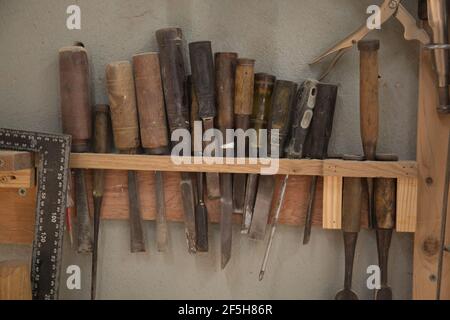 Closeup shot of old working tools hanging Stock Photo
