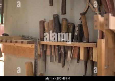Closeup shot of old working tools hanging Stock Photo
