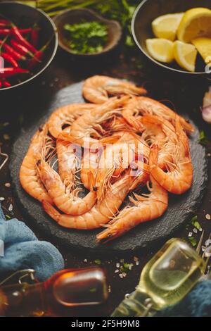 Fresh and raw big shrimps ready to be prepared. With various ingredients on side Stock Photo