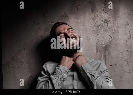A handsome young man with a beard. The emotions of a man. Depression or hopelessness. Dramatic emotional portrait of a man. High quality photo Stock Photo