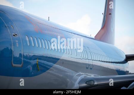 Glasgow, Scotland, UK. 26th Mar, 2021. PICTURED: Sunwing jet plane seen in Tui colours sits on the airport tarmac. Tui has reduced its capacity for this summer from 80% to 75% of 2019's level, with summer bookings appearing to have stalled, whilst operator Tui described bookings as “encouraging” at the group's annual general meeting (AGM) yesterday. The company reported group bookings for summer 2021 remain unchanged at 2.8 million, the same figure it reported in early February, leaving bookings 60% down on the comparable period in 2019. Credit: Colin Fisher/Alamy Live News Stock Photo