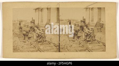 Men laying down train tracks. Unknown Stock Photo