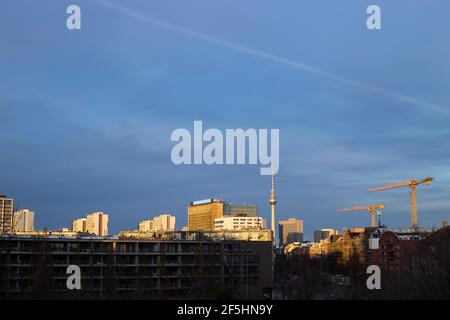 Berlin, Germany 31-12-2020 Fernsehturm and construction site along Lindenstrasse, LED display on Axel Springer building blinks in background. Stock Photo