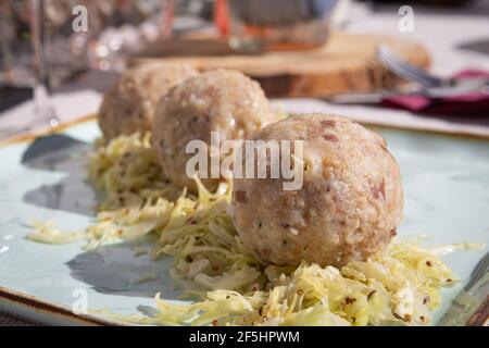 A picture of a plate of Canederli, a typical italian pasta made with bread, Cortina D'Ampezzo, Italy Stock Photo
