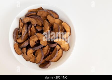 Homemade sun-dried organic apple slices on white background, crispy apple chips. Flat lay. Stock Photo