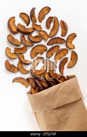 Dried apples and paper bag on white background. Top view. Stock Photo