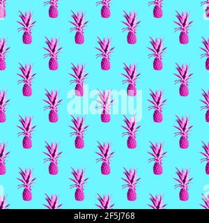 Seamless pattern of pink pineapples isolated on blue background Stock Photo