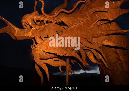 Borrego Springs, CA. March 23, 2021. A 350-foot long sculpture of a dragon-serpent b Mexican artist Ricardo Breceda under a stormy sky. Stock Photo