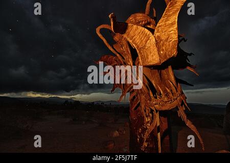 Borrego Springs, CA. March 23, 2021. A 350-foot long sculpture of a dragon-serpent b Mexican artist Ricardo Breceda under a stormy sky. Stock Photo