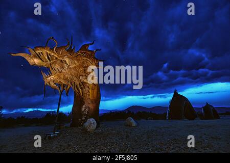 Borrego Springs, CA. March 23, 2021. A 350-foot long sculpture of a dragon-serpent b Mexican artist Ricardo Breceda under a stormy sky. Stock Photo