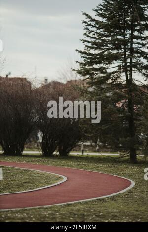 Empty red soft jogging track in the park Stock Photo