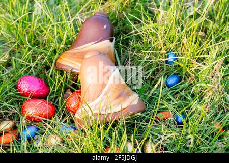 Easter. Two chocolate bells and Easter eggs, in the grass Stock Photo