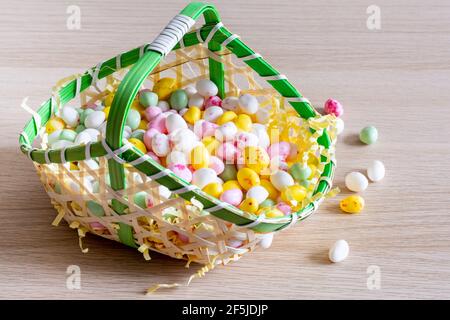 Easter. Basket filled with small sugar eggs Stock Photo