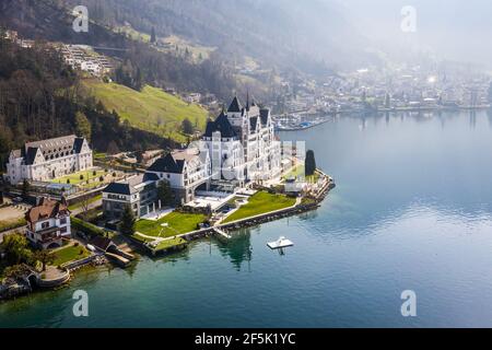 Vitznau, Switzerland - March 28 2020: Dramatic aerial view of the luxury Park Hotel Vitznau that lies by lake Lucerne in Central Switzerland Stock Photo