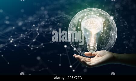 Businessman holding Light bulbs with Brain inside the Low poly wireframe sphere. Creative and innovation inspiration. Business Bright idea concept. Stock Photo