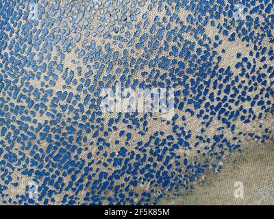 Old leather texture. Blue cracked skin. Dotted blue texture on the fabric. Stock Photo