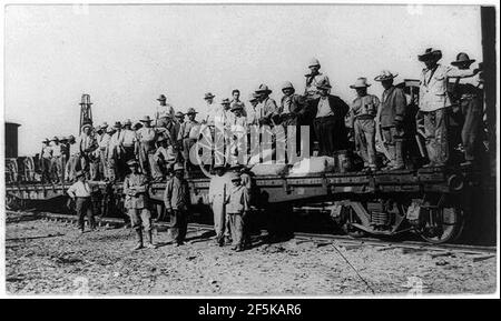 Railroad trains transporting Insurrectos during the Mexican Revolution- Soldiers standing on 2 flat cars Stock Photo