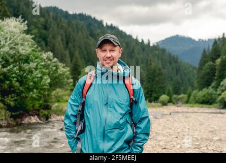 Young tourist standing on mountain background Stock Photo