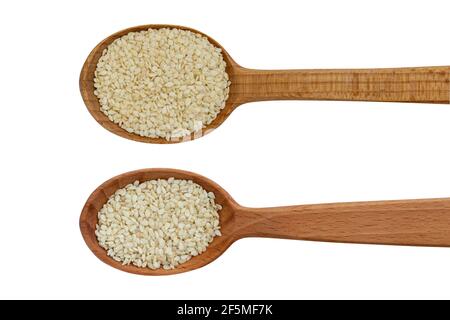 Sesame seeds in a wooden spoon isolated on white background top view. Close-up. Stock Photo