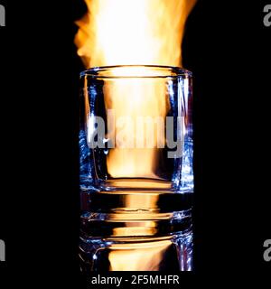 empty glass of brandy on fire, isolate Stock Photo