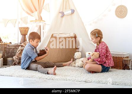 Little boy taking pictures of little girl Stock Photo