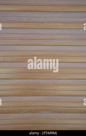 Brown colored plastic wall, door of a garage, vinyl siding with wood texture imitation, abstract background with horizontal tiles Stock Photo