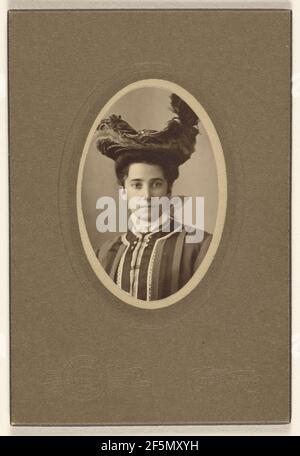 Unidentified woman wearing a feathered hat, printed in oval cut. Bloomingdale Brothers Stock Photo
