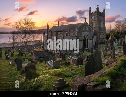 Appledore, North Devon, England. Saturday 27th March 2021. UK Weather. A beautiful start to the day over the River Torridge estuary, as the sun lights up the small churchyard of St. Mary's and the springtime primroses, in the picturesque coastal village of Appledore. Credit: Terry Mathews/Alamy Live News Stock Photo