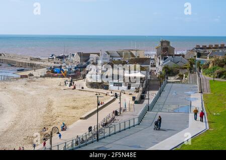 Lyme Regis, Dorset, UK. 27th Mar, 2021. UK Weather: After a chilly start there were plenty of warm sunny spells at the seaside resort of Lyme Regis today. Locals were about early enjoying the spring sunshine, but the beach was quiet for this time of year. The pretty seaside town is expected to be busier next week as coronavirus lockdown restrictions finally start to ease. Credit: Celia McMahon/Alamy Live News Stock Photo