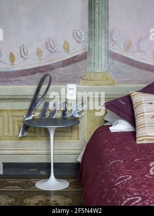 Interior of a beautiful bedroom in a house in Florence Italy. Detail of fresco on the wall and decoration. Stock Photo