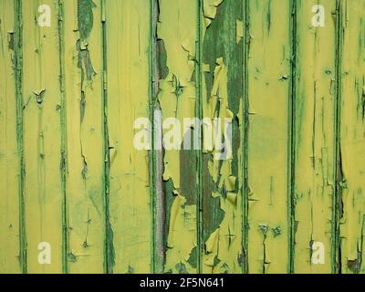 Green wooden wall where the paint is peeling Stock Photo
