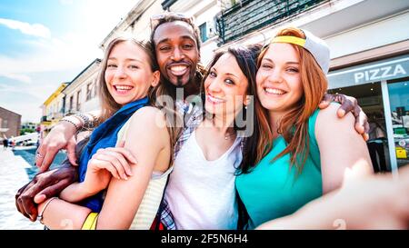 Multicultural tourists group taking selfie at old town tour - Happy millenial life style concept with young people having fun around city Stock Photo